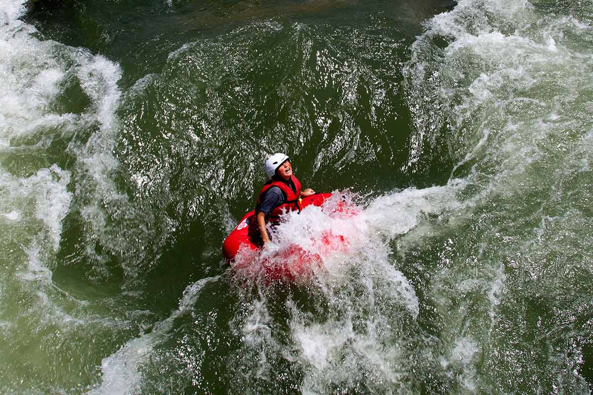 tuber in a wave with a scared face
