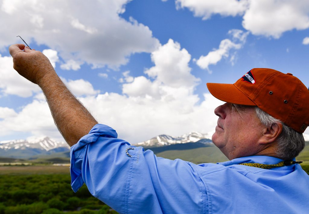 Fisherman Charles Duke prepares his line before heading into the river.