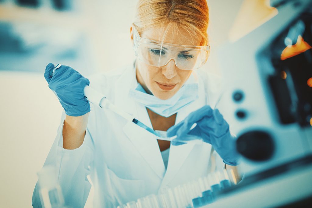 A lab technician prepares a blood sample in a lab.
