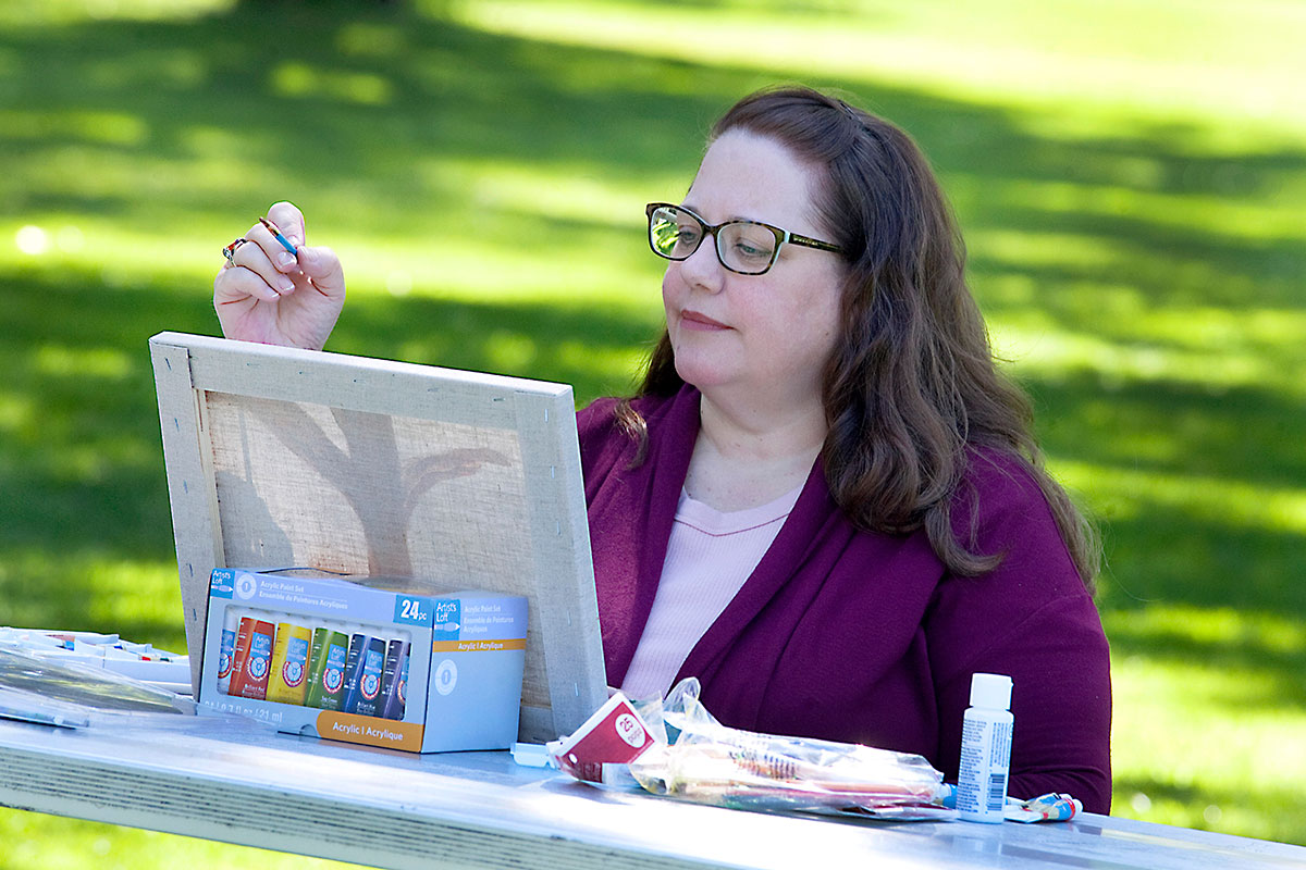 Karla enjoys painting in the park because she's managed her diabetes with diabetes education.