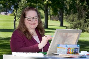 Karla enjoys painting in the park because she's managed her diabetes with diabetes education.