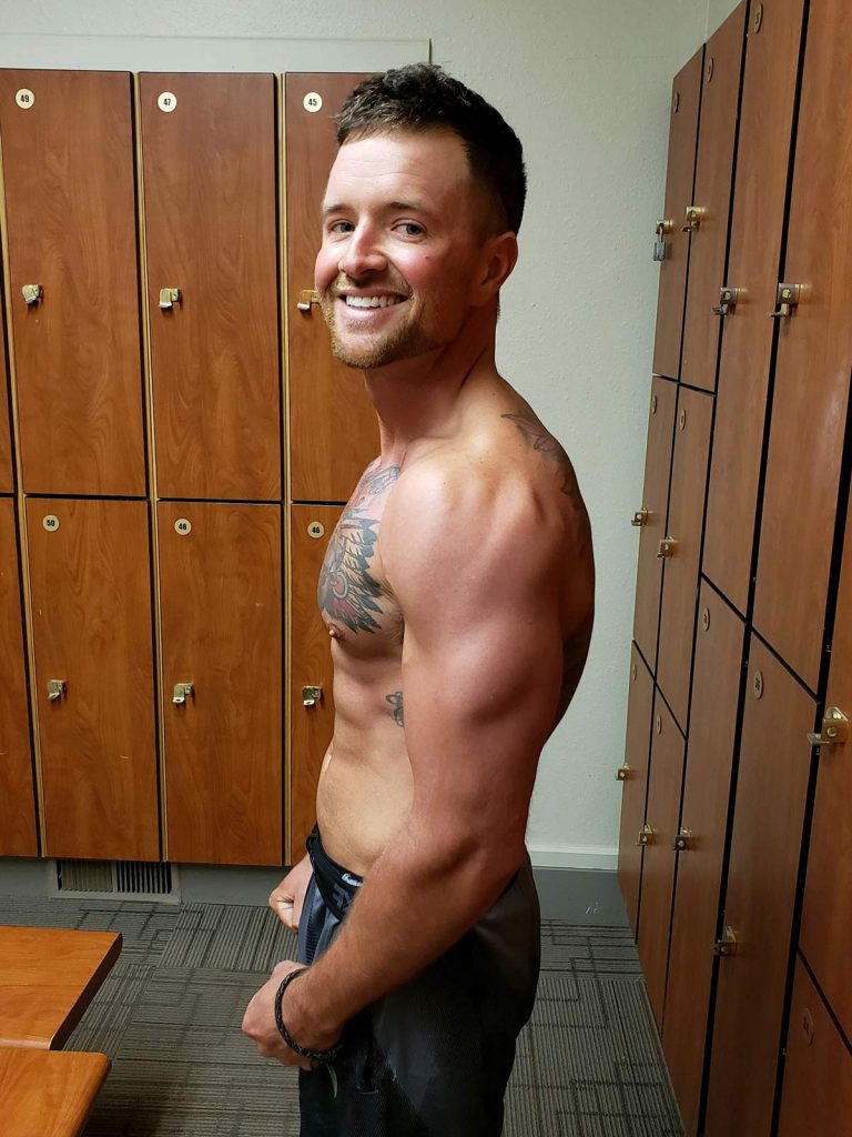 Nathan Kissack posing without a shirt after working out to get fit from cancer.