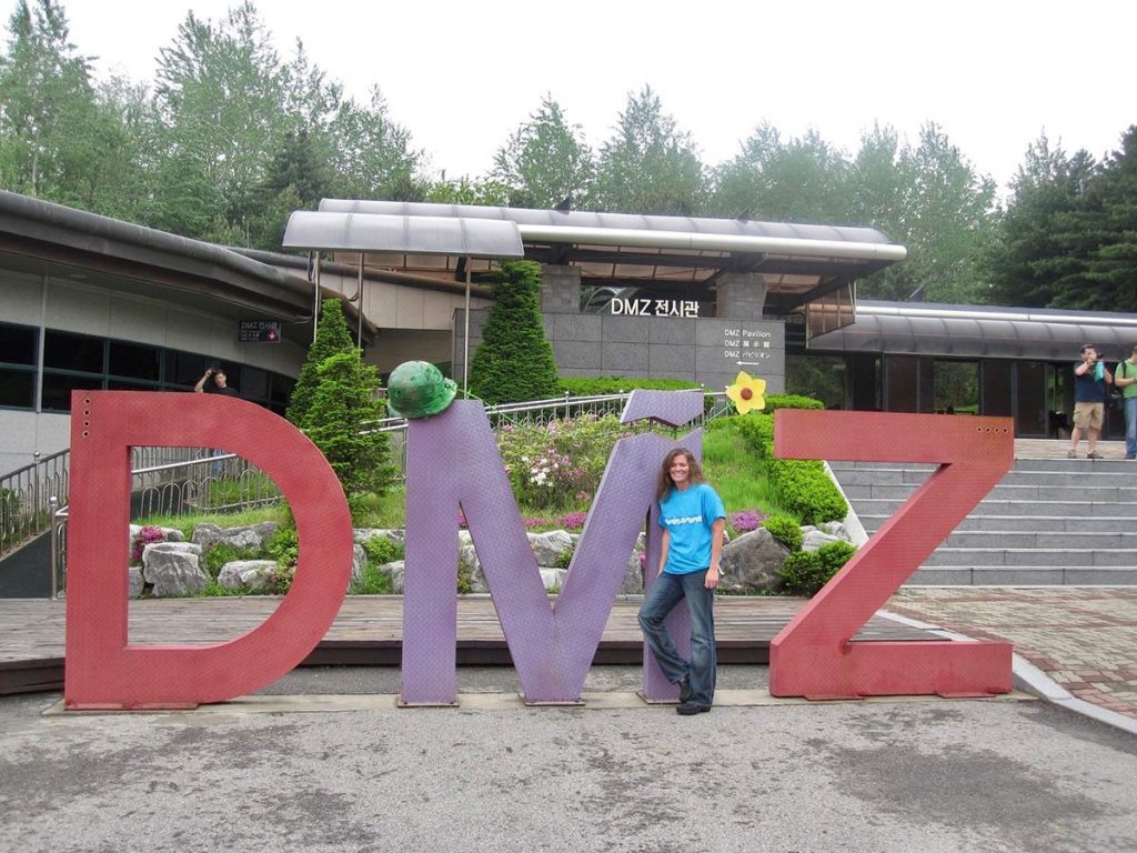 Marybeth Hoffman posing in front of the DMZ sign