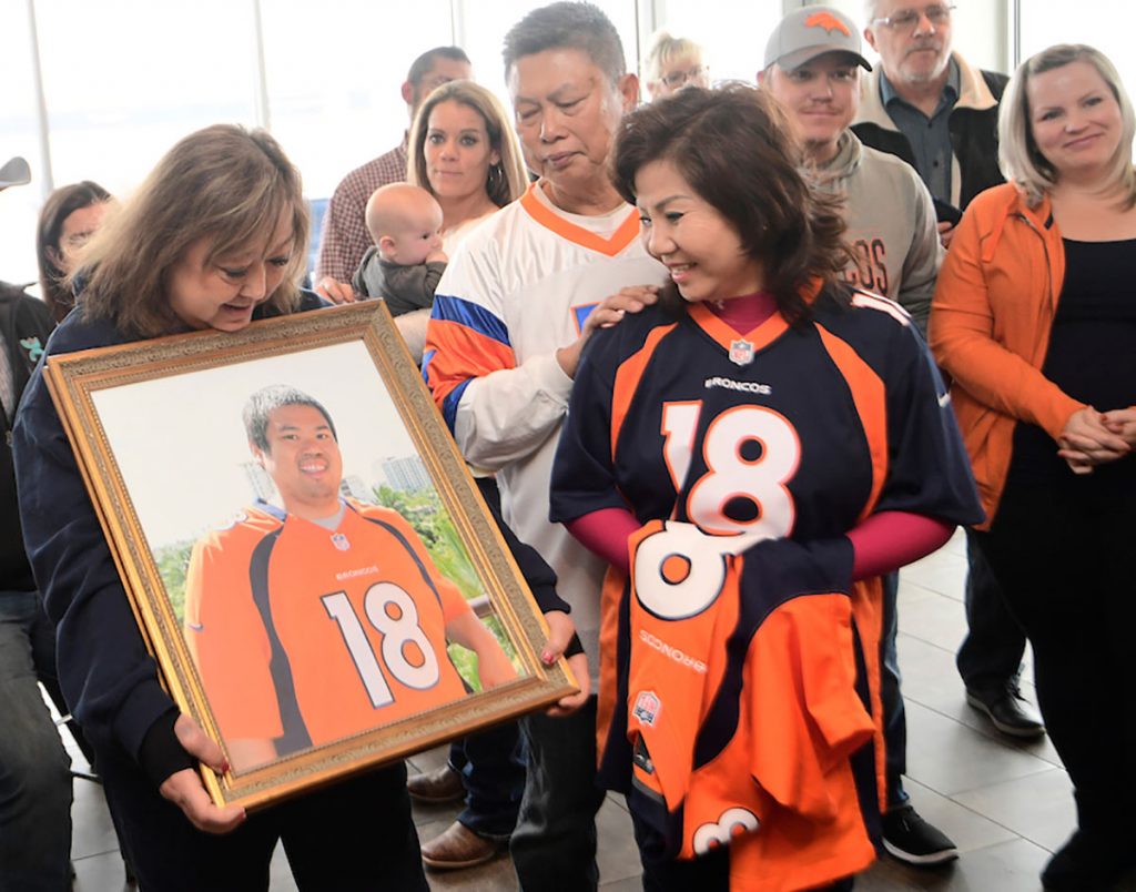 Mom holding a portrait of her son, while transplant recipient meets family of the donor who saved her life.