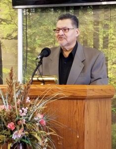 Michael speaking at the church podium.