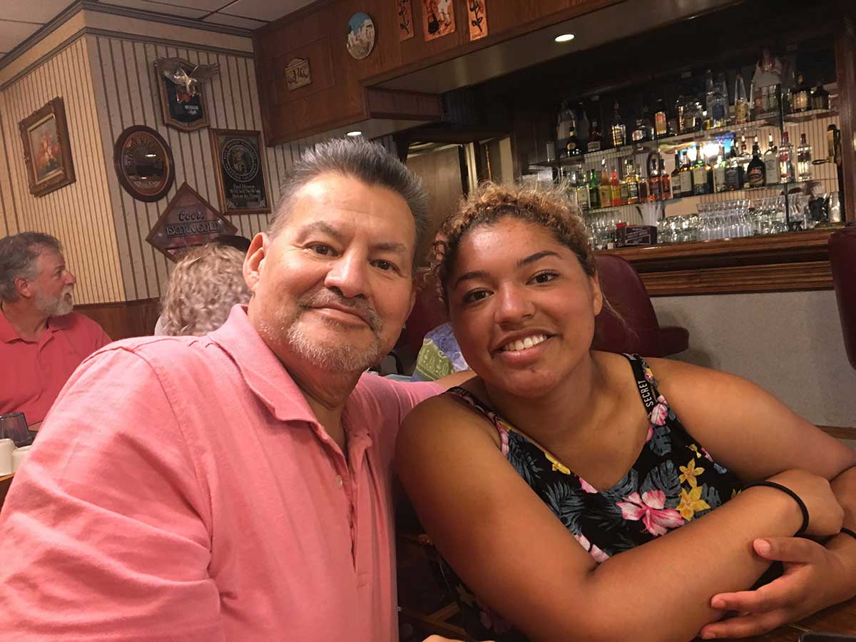 Grandfather poses with arm around his granddaughter, a bond that helped her deal with the realities of cancer.