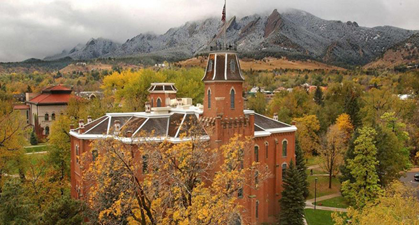 Old Main at the University of Colorado in Boulder with the snow-dusted Flatirons in the background