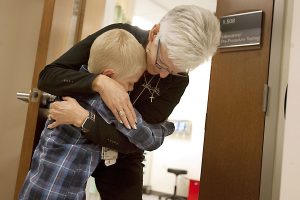 Boy hugs his phlebotomist at the hospital before a blood draw.