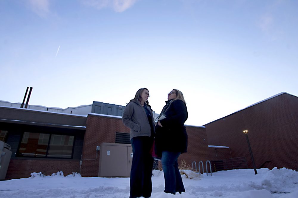 Nurse and sister stand outside of the hospital