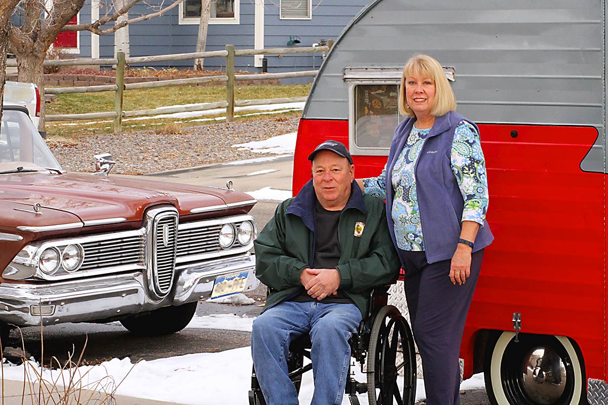 Rich in a wheelchair and Sue in front of their classic 1950s camper and car. they enjoy those things in retirement but had to focus on health a bit more after being in the prediabetes range.