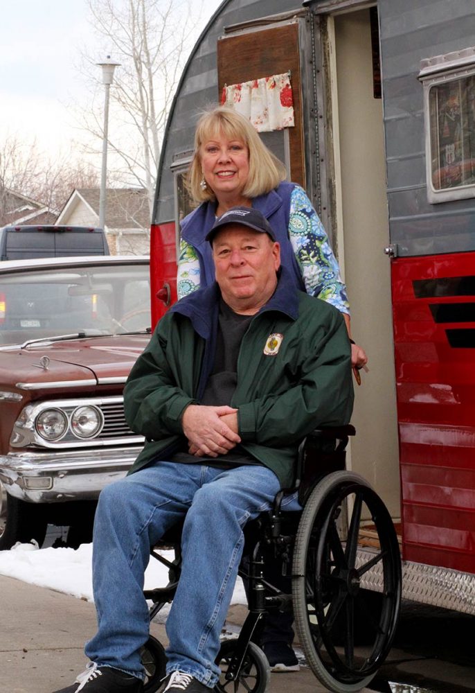 Rich in a wheelchair and Sue in front of their classic 1950s camper and car. they enjoy those things in retirement but had to focus on health a bit more after being in the prediabetes range.