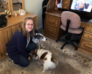 Julie Singles, who said a new procedure that helps in targeting breast tissue is much better than the old way, with her dogs.