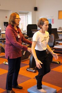 Woman navigates MS with help from physical therapist in rehab gym
