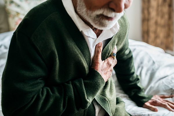 older adult holding his heart