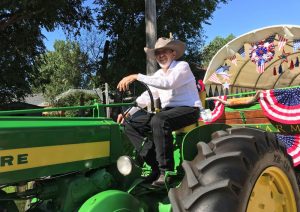 Jack Silva, a heart disease patient, on his tractor at a local parade.