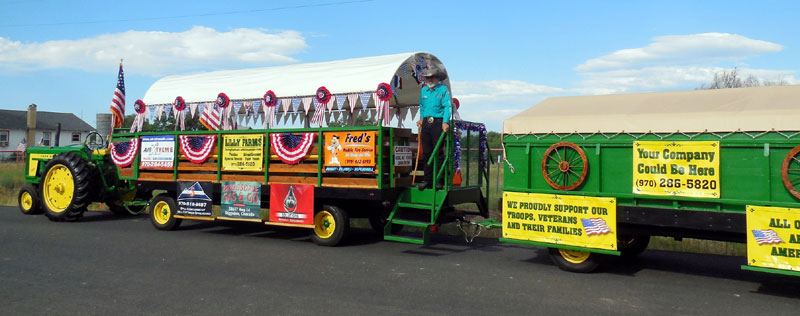 Jack Silva's tractor pulling the rest of his float: wagons with banners on it. it was something he started after becoming a heart disease patient.