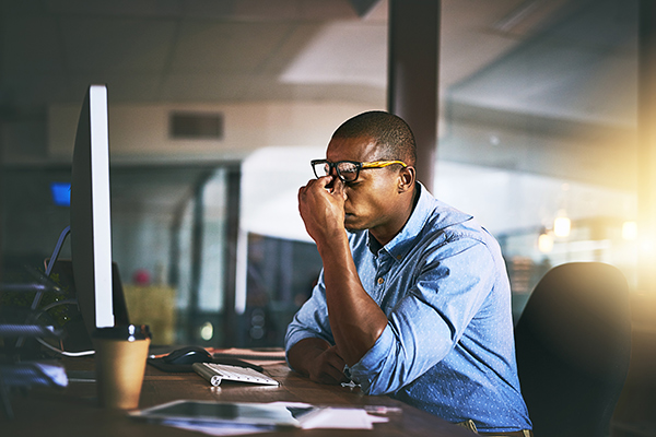 A tired man. Learn tips for dealing with the time change and getting better sleep.