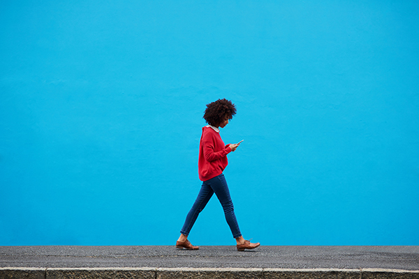 A person walking alone. In order to change the coronavirus math, we must practice physical distancing.