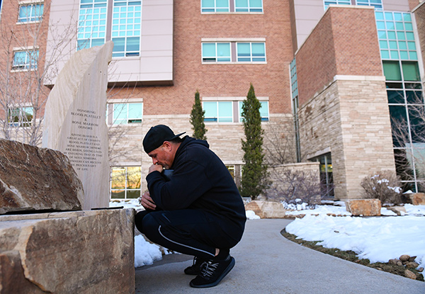Son prays outside the hospital room of his dad, Sergio Rodriguez, a longtime JBS worker who got sick with COVID-19.