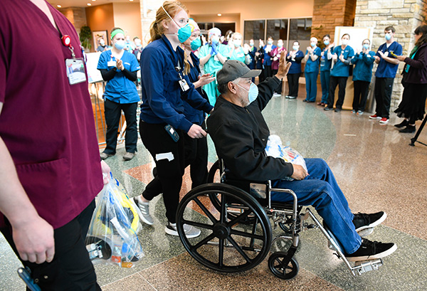 JBS worker with COVID-10, Sergio Rodriguez, gets applause and cheers from workers as he leaves the hospital.