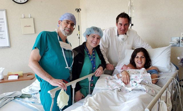 mom, baby, dad and doctors after giving birth during the pandemic.