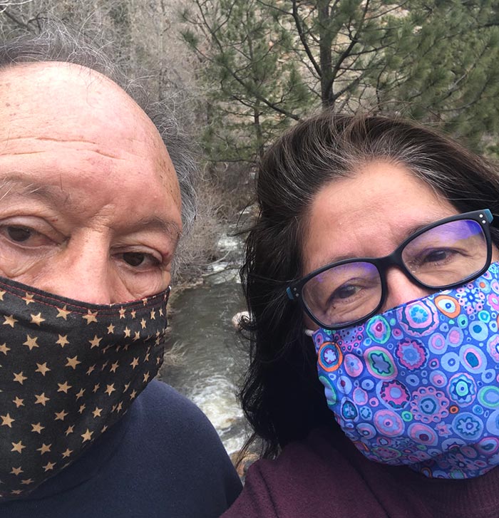 selfie of sam and paula wearing masks on a hike