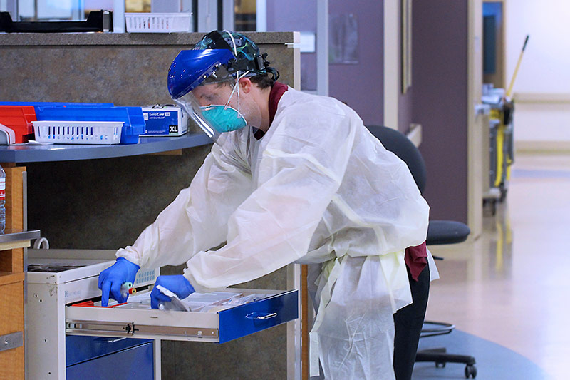 Covid-unit nurse getting something out of a drawer. nurses are now giving dexamethasone to some coronavirus patients.