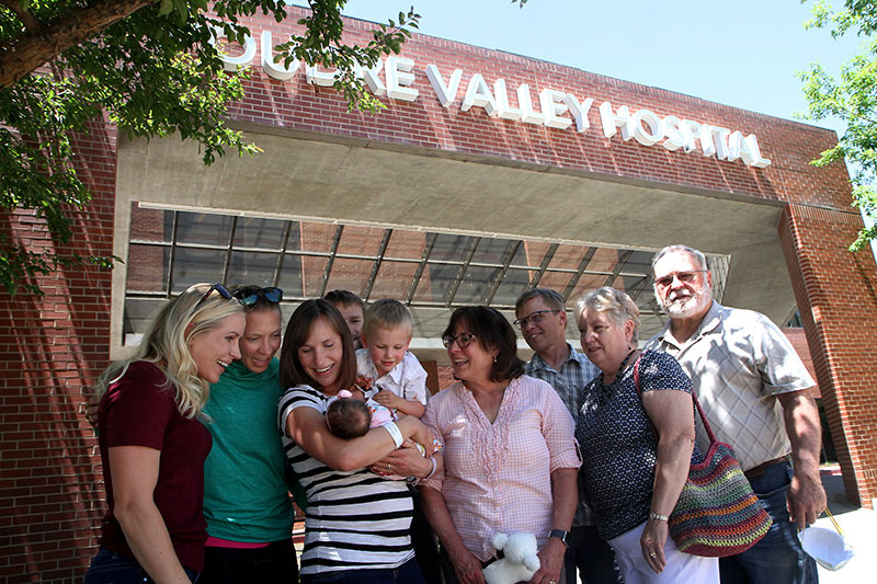 family members stand outside poudre valley hospital, including the 4 generations born at that same hospital..