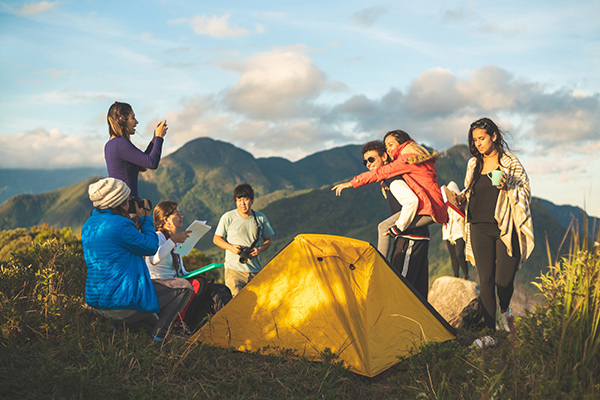 Camping in Colorado during the COVID-19 pandemic can be a great way to enjoy nature while staying safe. A family camping on a ridge over lookign the mountains. Photo: Getty Images.