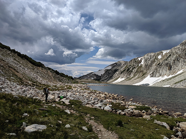 Camping in Colorado durnig COVID-19 can be a great escape. Photo of Dr. Nancy Madinger backpacking in the Snowy Range in Wyoming.