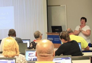 Students at computers while instructor talks