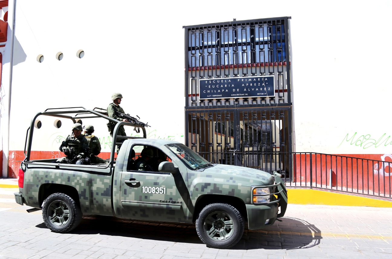 Soldados del Ejército mexicano frente a la escuela primaria Eucaria Apreza, de Chilapa, también cerrada ante la negativa de los profesores de regresar a clases debido a amenazas de la delincuencia organizada que opera en esta zona. Foto: Jesús Eduardo Guerrero