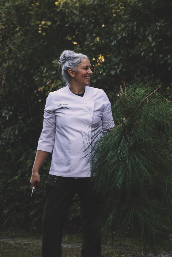 a chef cuts pine branches