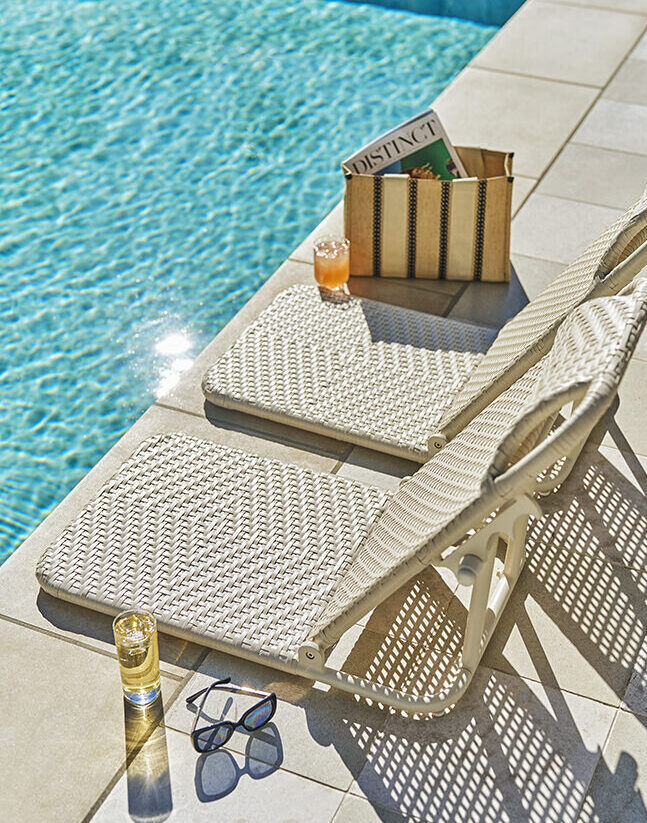 Lounge Chairs next to a pool.