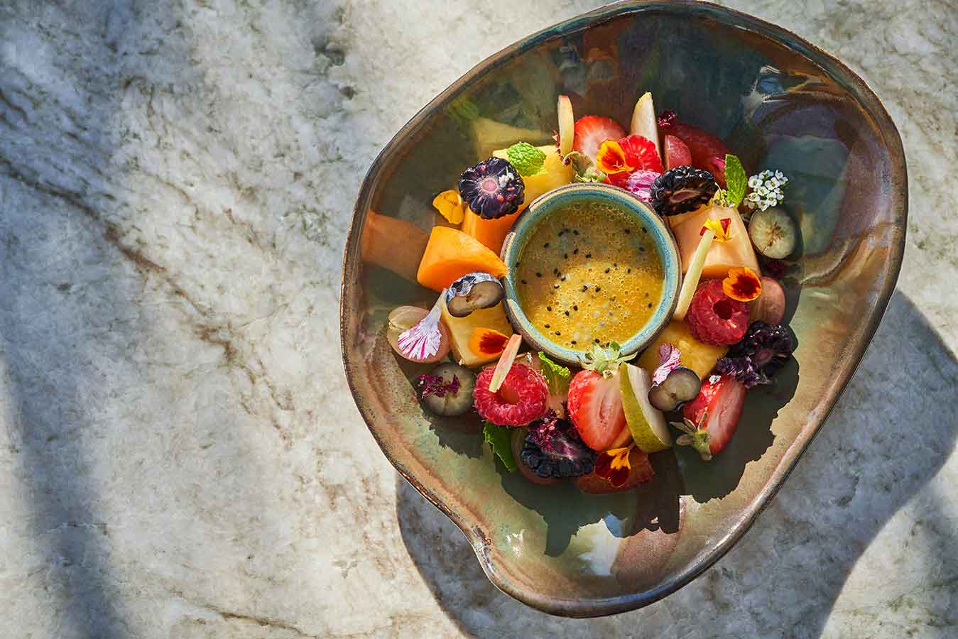 a meal with fruits, flowers and dip at Hazel Hill in Healdsburg