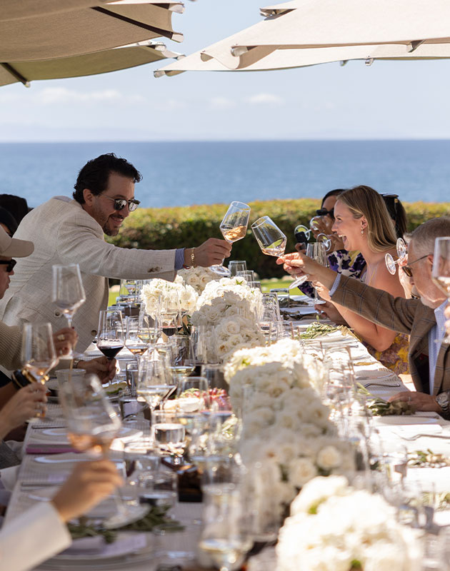 Friends toasting at the table outside of Montage Healdsburg