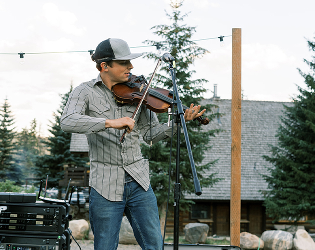 Man playing violin at a Big Sky concert
