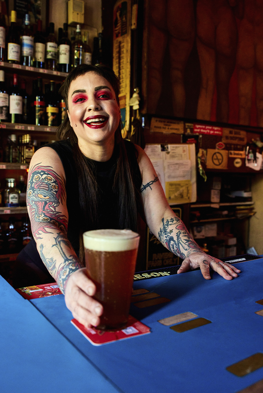 A woman holding a beer at a bar in Baltimore