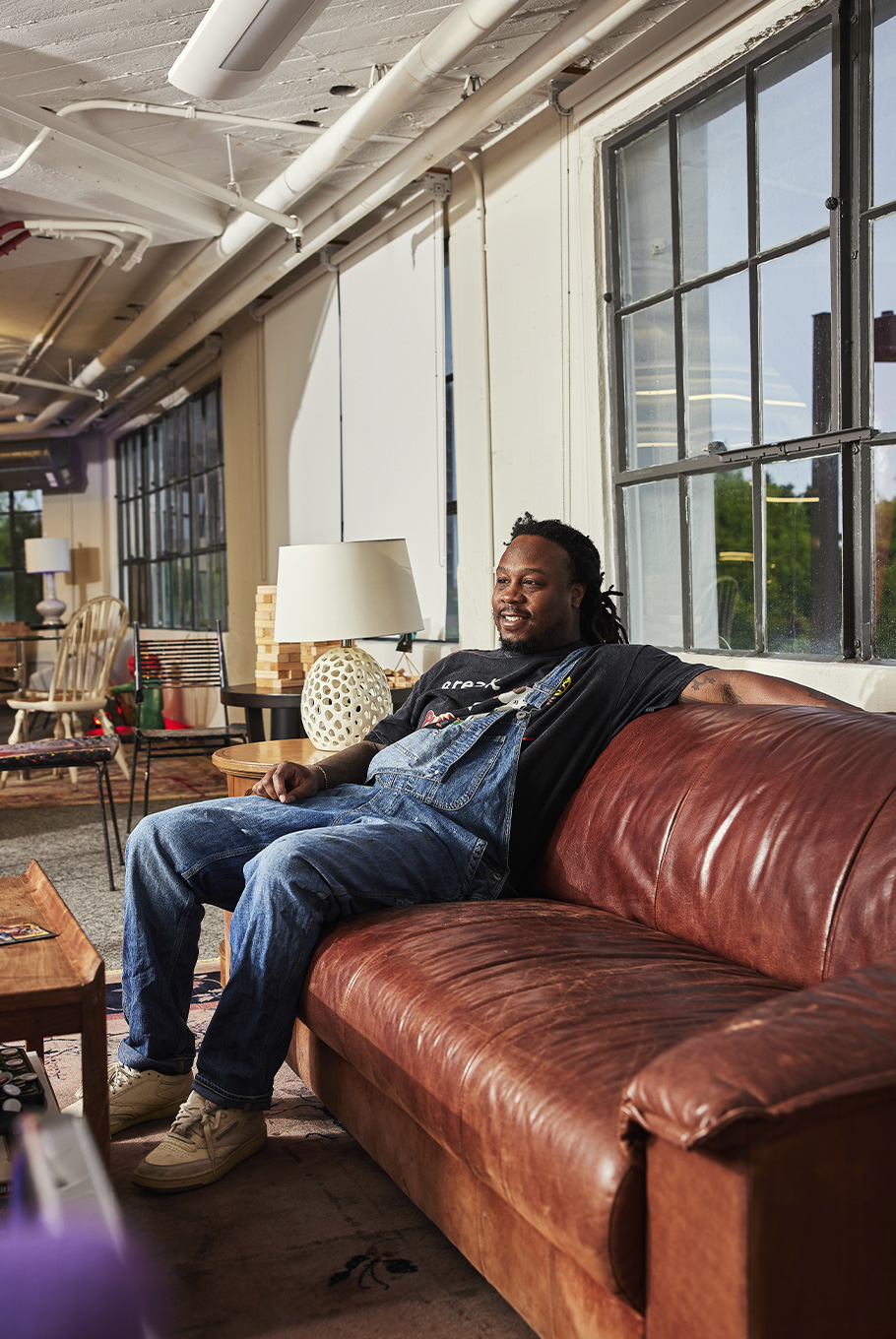 A man sitting on a couch in a Baltimore art studio