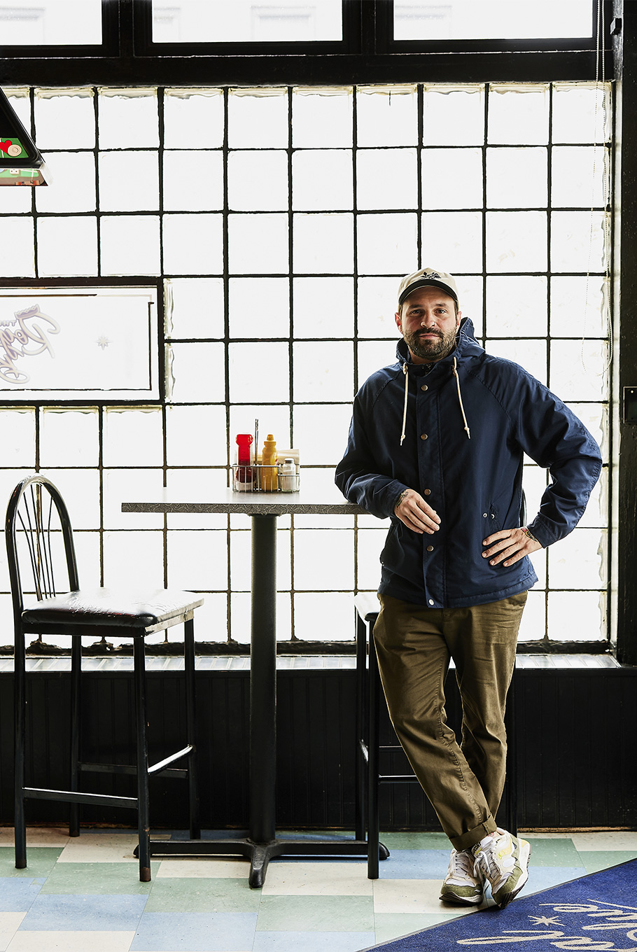A man leaning against a table at a Baltimore restaurant
