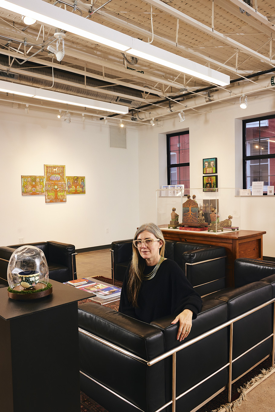 A woman sitting on a couch in a Baltimore art studio