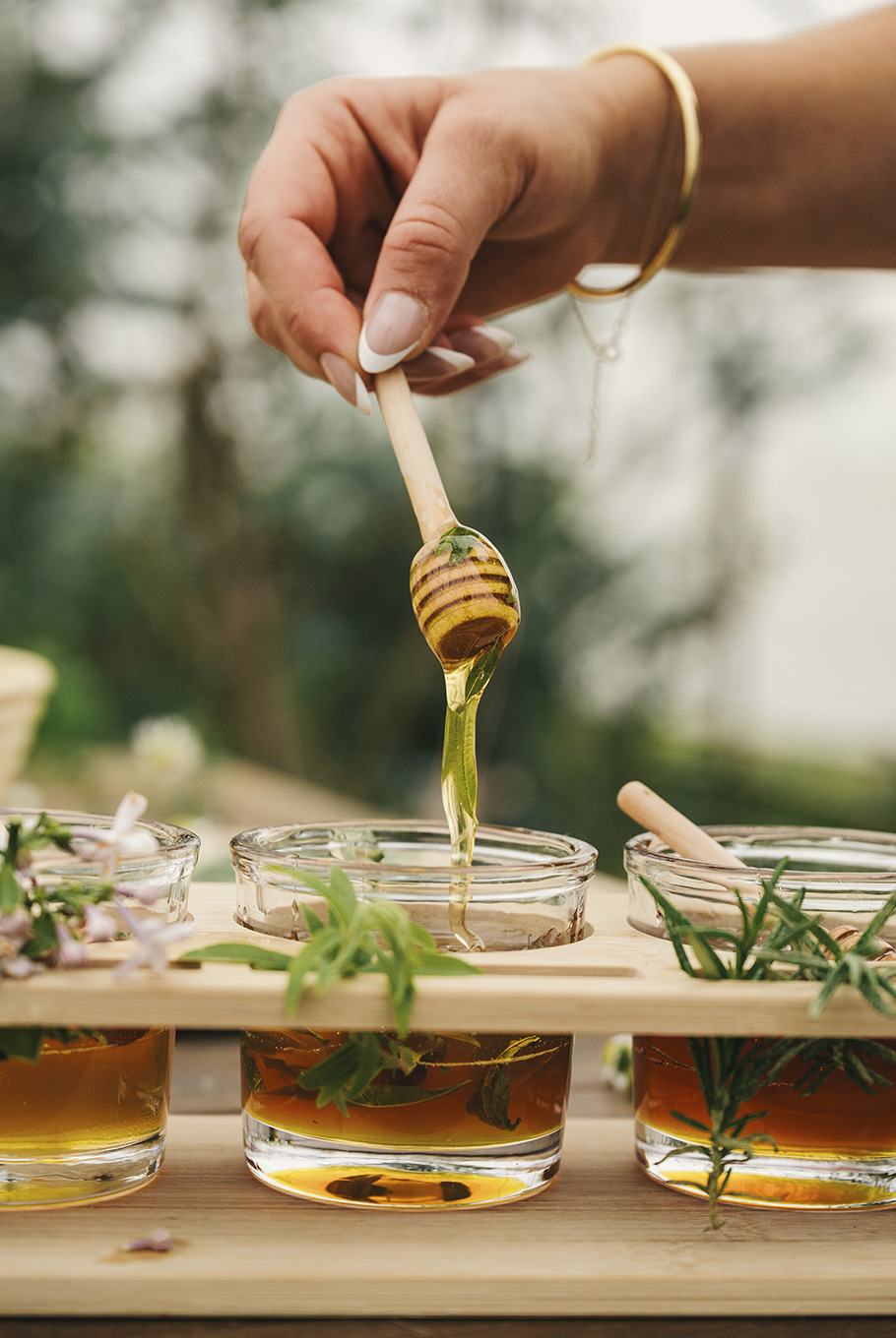 A person making honey at Pendry Natirar