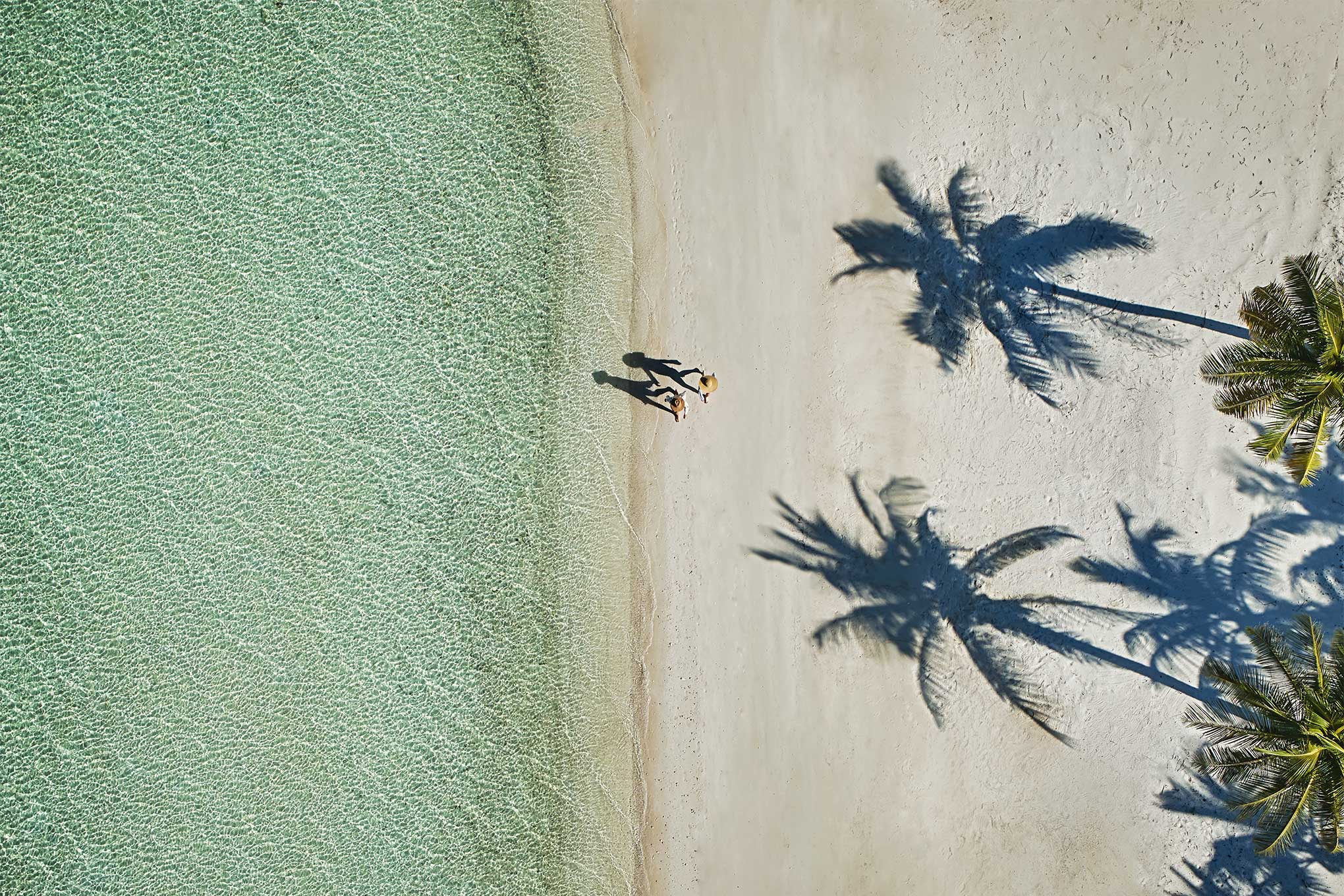Two people walking on the beach in the abacos bahamas resorts