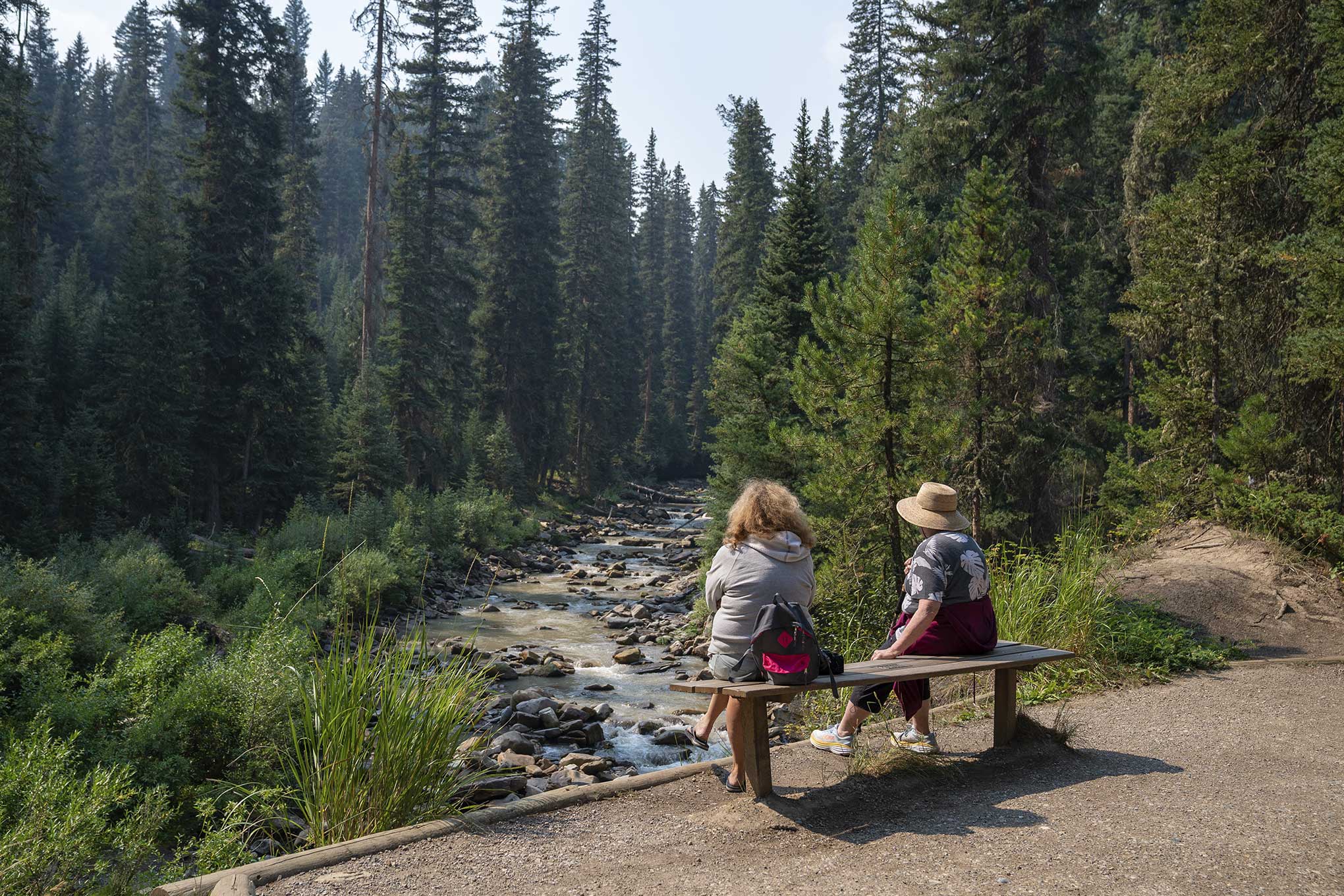 Two people looking at Ousel Falls in Big Sky