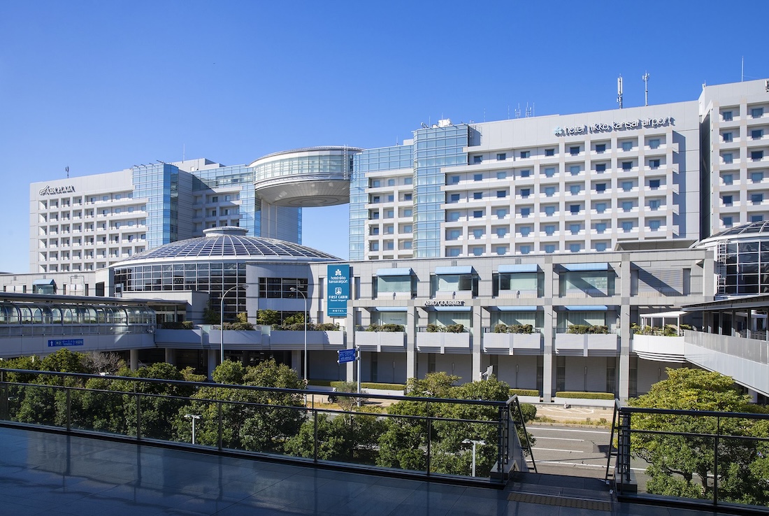 Hotel Nikko Kansai Airport, a large modern complex with glass facades and a circular skybridge, located next to the airport.
