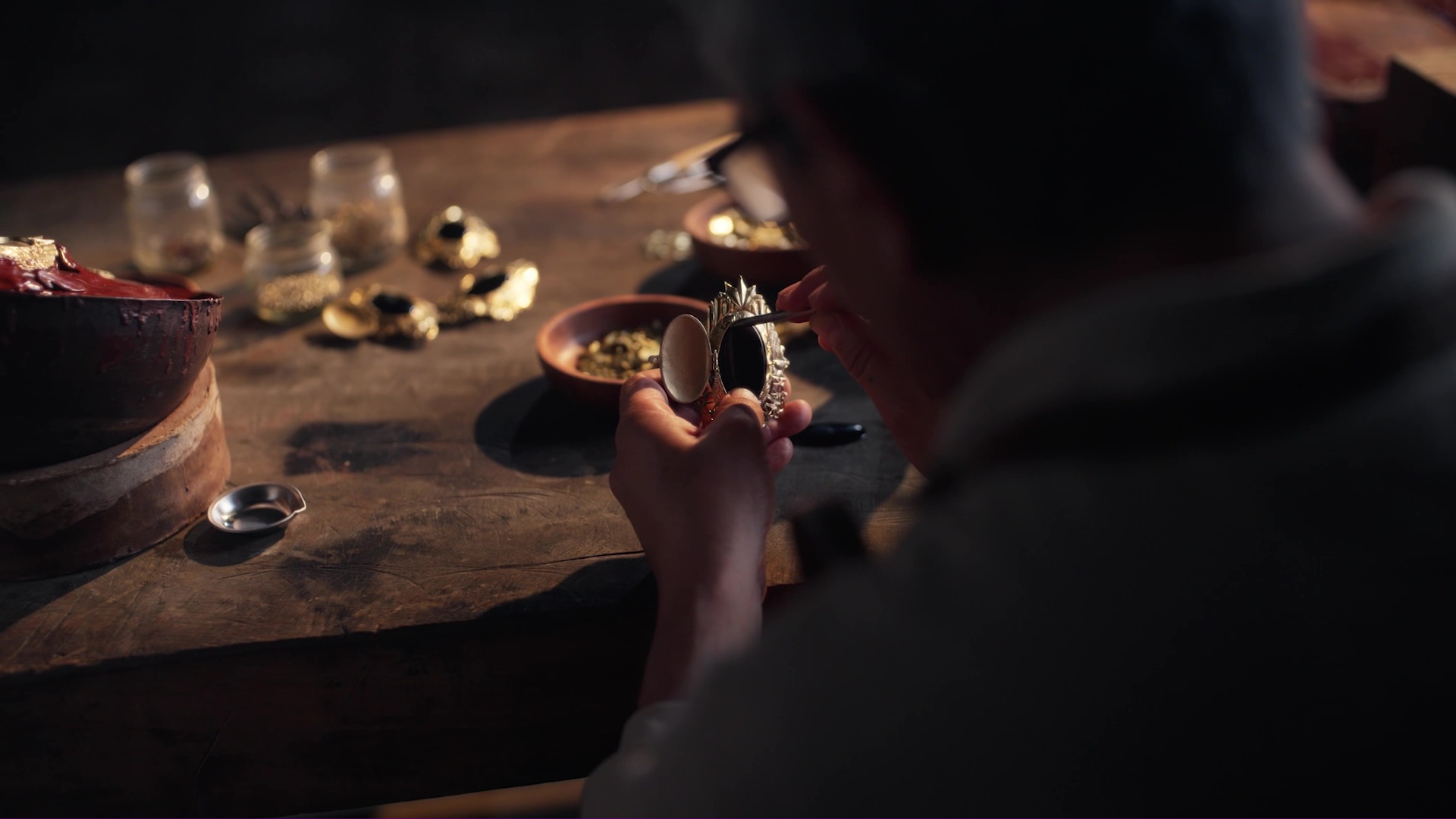 Close-up of someone painting a decorative element for a decanter