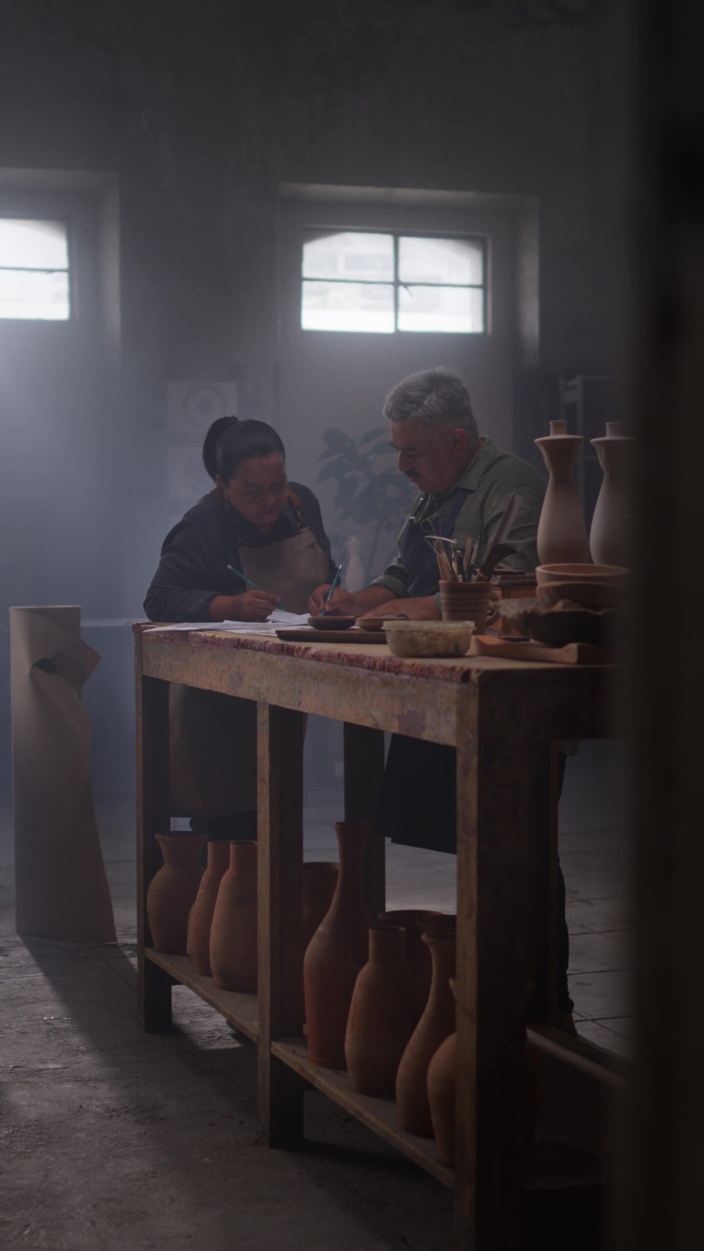 Two people working together on a decanter design