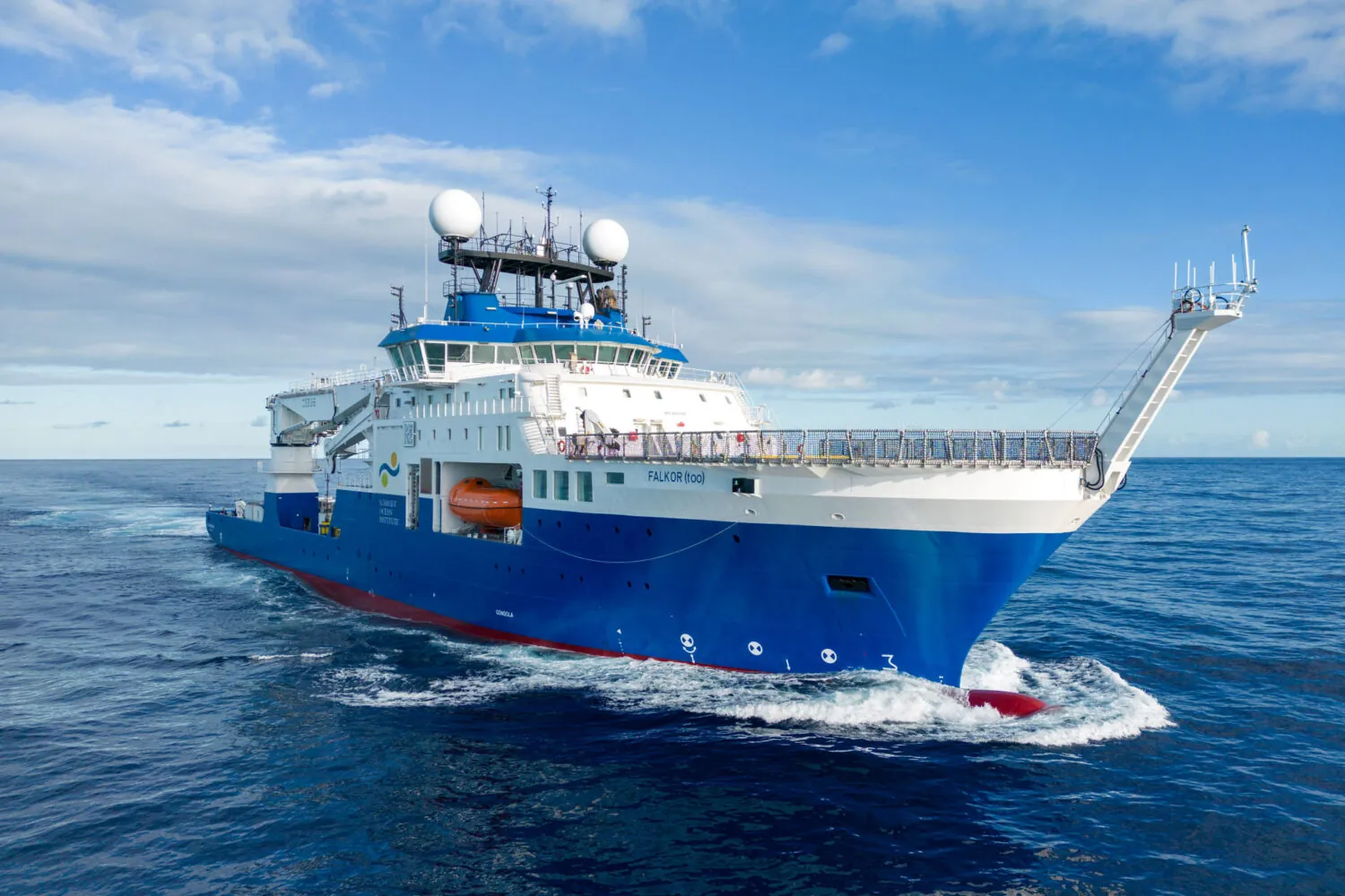 White and blue ship in the ocean during daylight.