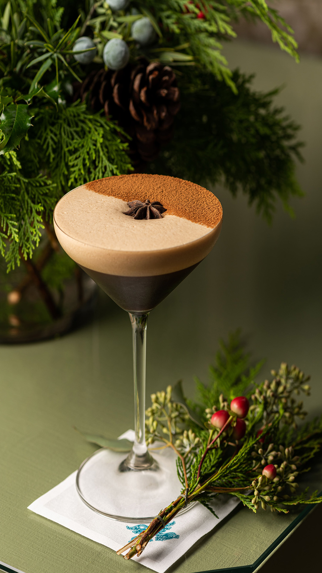 an espresso martini with holiday garland around the glass