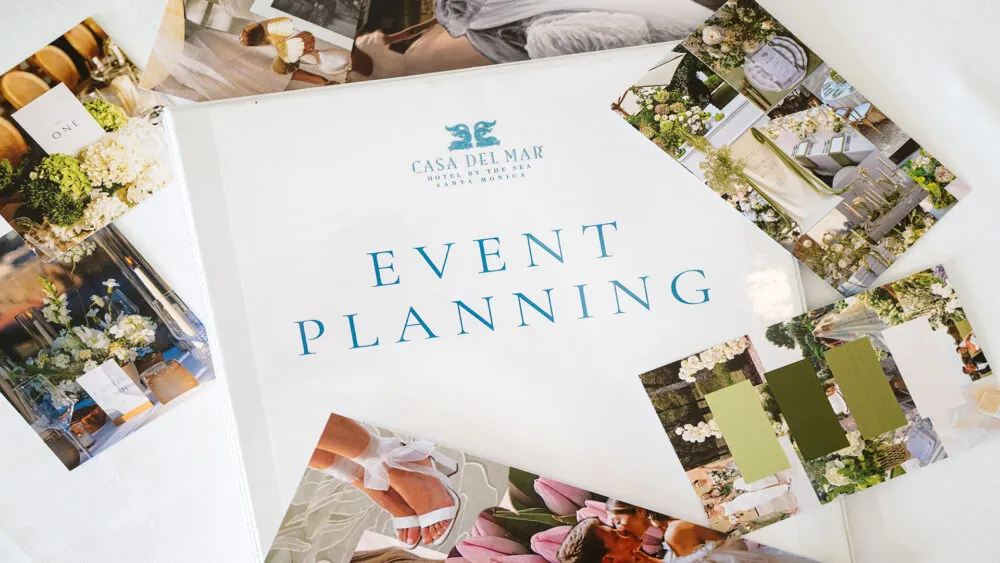 Event planning binder labeled 'Casa del Mar' surrounded by photos of floral arrangements.